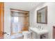 Clean bathroom featuring a glass-enclosed shower with tiled walls and a modern pedestal sink at 2323 N Central Ave # 1902, Phoenix, AZ 85004