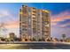 Modern high-rise apartment building with balconies, parking lot, and desert landscaping at 2323 N Central Ave # 1902, Phoenix, AZ 85004