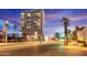 Beautiful exterior of a high-rise building featuring balconies, street view, palm trees, and lovely sunset sky at 2323 N Central Ave # 1902, Phoenix, AZ 85004