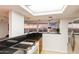 A modern kitchen with stainless steel appliances, tile flooring, and a breakfast bar at 2323 N Central Ave # 1902, Phoenix, AZ 85004