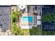 Aerial view of a community pool with lounge chairs, fire pit, spa, outdoor seating, and parking at 2323 N Central Ave # 1902, Phoenix, AZ 85004