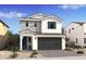 Charming two-story home featuring a gray garage door, board and batten siding, and blue front door at 2393 W Mariposa St, Chandler, AZ 85224