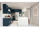 Bright kitchen showcases an island with a white countertop and open shelving, stainless appliances, and blue cabinets at 2393 W Mariposa St, Chandler, AZ 85224