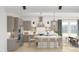 Bright, modern kitchen boasts a large island, stainless steel appliances, and stylish light fixtures at 2393 W Mariposa St, Chandler, AZ 85224