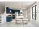 Modern kitchen with white counters, stainless appliances, pendant lighting, and dining area near the staircase at 2393 W Mariposa St, Chandler, AZ 85224