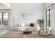 Inviting living room features a large window, modern furniture, neutral colors, and a cozy rug at 2393 W Mariposa St, Chandler, AZ 85224
