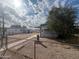 Cozy single-story home featuring a fenced yard and covered patio under bright sky at 240 S Ellsworth Rd, Mesa, AZ 85208