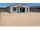 View of backyard featuring zero scaping and a gray house with a covered patio at 24369 W La Salle St, Buckeye, AZ 85326