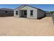 View of backyard featuring zero scaping and a gray house with a covered patio at 24369 W La Salle St, Buckeye, AZ 85326