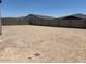 View of backyard featuring zero scaping and a tall block wall at 24369 W La Salle St, Buckeye, AZ 85326