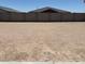 View of backyard featuring zero scaping and a tall block wall at 24369 W La Salle St, Buckeye, AZ 85326