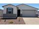 Charming single-story home featuring a well-maintained front yard and a two-car garage at 24369 W La Salle St, Buckeye, AZ 85326