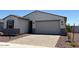 Well-maintained exterior showcasing a charming home with a paved driveway and low maintenance landscaping at 24369 W La Salle St, Buckeye, AZ 85326
