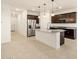 Open concept kitchen featuring an island, granite countertops, and stainless steel appliances at 24369 W La Salle St, Buckeye, AZ 85326