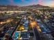 Beautiful aerial view showcasing a pool and mountain views in a well-lit neighborhood at night at 316 E El Camino Dr, Phoenix, AZ 85020