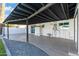 Spacious covered patio area with tile flooring, providing a comfortable outdoor space for relaxation and dining at 316 E El Camino Dr, Phoenix, AZ 85020