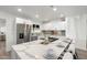 Gorgeous kitchen featuring stainless steel appliances, white cabinets, and an eat-in island at 316 E El Camino Dr, Phoenix, AZ 85020