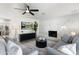 Comfortable living room showcasing the fireplace, modern fan, and neutral furniture arrangement at 316 E El Camino Dr, Phoenix, AZ 85020