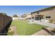 Spacious backyard featuring a built-in grill, fire pit, and lush green lawn at 3423 E Superior Rd, San Tan Valley, AZ 85143