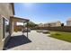 Spacious backyard featuring a built-in grill, fire pit, and lush green lawn at 3423 E Superior Rd, San Tan Valley, AZ 85143
