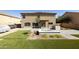 An expansive backyard with an outdoor kitchen, a patio, a built-in fire pit, and well-maintained landscaping at 3423 E Superior Rd, San Tan Valley, AZ 85143