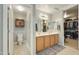 Well-lit bathroom with double vanity, tile floors, and a walk-in closet at 3423 E Superior Rd, San Tan Valley, AZ 85143