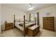 Cozy bedroom with a four-poster bed, dresser, and nightstands with a ceiling fan at 3423 E Superior Rd, San Tan Valley, AZ 85143