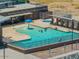 Aerial view of the community pool featuring a splash area, spa, shade structures, and lounge seating at 3423 E Superior Rd, San Tan Valley, AZ 85143