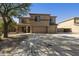 Two-story home boasts a three-car garage, desert landscaping, and neutral stucco exterior at 3423 E Superior Rd, San Tan Valley, AZ 85143