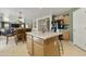 A kitchen with an island, breakfast bar, tile floors, and dark appliances at 3423 E Superior Rd, San Tan Valley, AZ 85143
