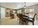 Bright kitchen with wood cabinets, a center island, and an adjacent dining area at 3423 E Superior Rd, San Tan Valley, AZ 85143