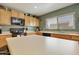 Functional kitchen features wood cabinetry, a kitchen island, and modern appliances at 3423 E Superior Rd, San Tan Valley, AZ 85143