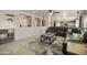 A spacious living room featuring a large leather sectional, neutral walls, and lots of natural light at 3423 E Superior Rd, San Tan Valley, AZ 85143