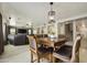 A living room that leads into a kitchen and has leather furniture and a large TV at 3423 E Superior Rd, San Tan Valley, AZ 85143