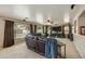 A spacious living room featuring a large leather sectional, neutral walls, and lots of natural light at 3423 E Superior Rd, San Tan Valley, AZ 85143
