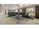 A spacious living room featuring a large leather sectional, neutral walls, and lots of natural light at 3423 E Superior Rd, San Tan Valley, AZ 85143
