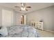 Comfortable bedroom featuring a ceiling fan, neutral walls, and a stylish white cabinet at 3423 E Superior Rd, San Tan Valley, AZ 85143