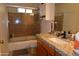 Bathroom features a shower-over-tub setup with glass doors, granite countertops, a vanity and a toilet at 3708 W Redfield Rd, Phoenix, AZ 85053