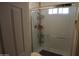 This bathroom features a shower with built-in shelving and glass doors, maximizing space and functionality at 3708 W Redfield Rd, Phoenix, AZ 85053
