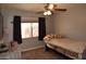 Bedroom with a window, ceiling fan, and neutral carpet at 3708 W Redfield Rd, Phoenix, AZ 85053
