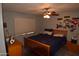 Bedroom with ceiling fan, comfortable bed, and personal decor at 3708 W Redfield Rd, Phoenix, AZ 85053