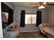 Bedroom with a television, dark curtains, and ceiling fan at 3708 W Redfield Rd, Phoenix, AZ 85053