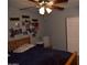 Bedroom with a ceiling fan, comfortable bed, and wall decor for a cozy atmosphere at 3708 W Redfield Rd, Phoenix, AZ 85053