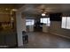 Spacious living room with tile floors, computer desk, and large windows that let in plenty of natural light at 3708 W Redfield Rd, Phoenix, AZ 85053