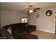 Comfortable living room features tile floors, a ceiling fan, and a large sectional sofa at 3708 W Redfield Rd, Phoenix, AZ 85053