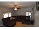 A comfortable living room features tile floors, a ceiling fan, and a large sectional sofa at 3708 W Redfield Rd, Phoenix, AZ 85053