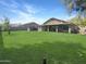 Expansive backyard featuring lush green grass, a private hot tub, and a covered patio, perfect for outdoor living at 3765 E Del Rio St, Gilbert, AZ 85295