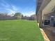 Spacious backyard featuring a covered patio, a private hot tub, and lush green grass at 3765 E Del Rio St, Gilbert, AZ 85295