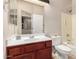 Well-lit bathroom featuring a vanity, toilet, mirror, and shower-tub combination at 3765 E Del Rio St, Gilbert, AZ 85295