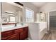 This bathroom features a vanity with a large mirror, a glass block window, and walk in shower at 3765 E Del Rio St, Gilbert, AZ 85295